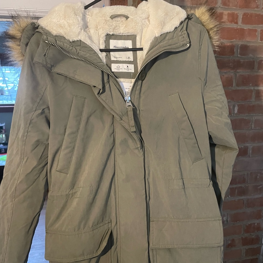 Woman’s winter jacket with faux fur hood